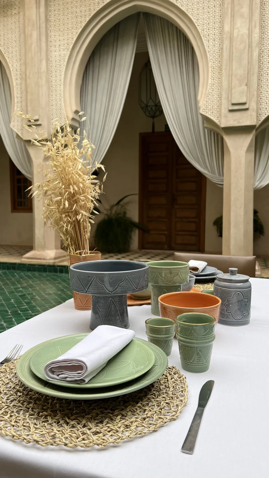 Riad Almaha courtyard, green pool and styled table, photographed by MarrakechStory